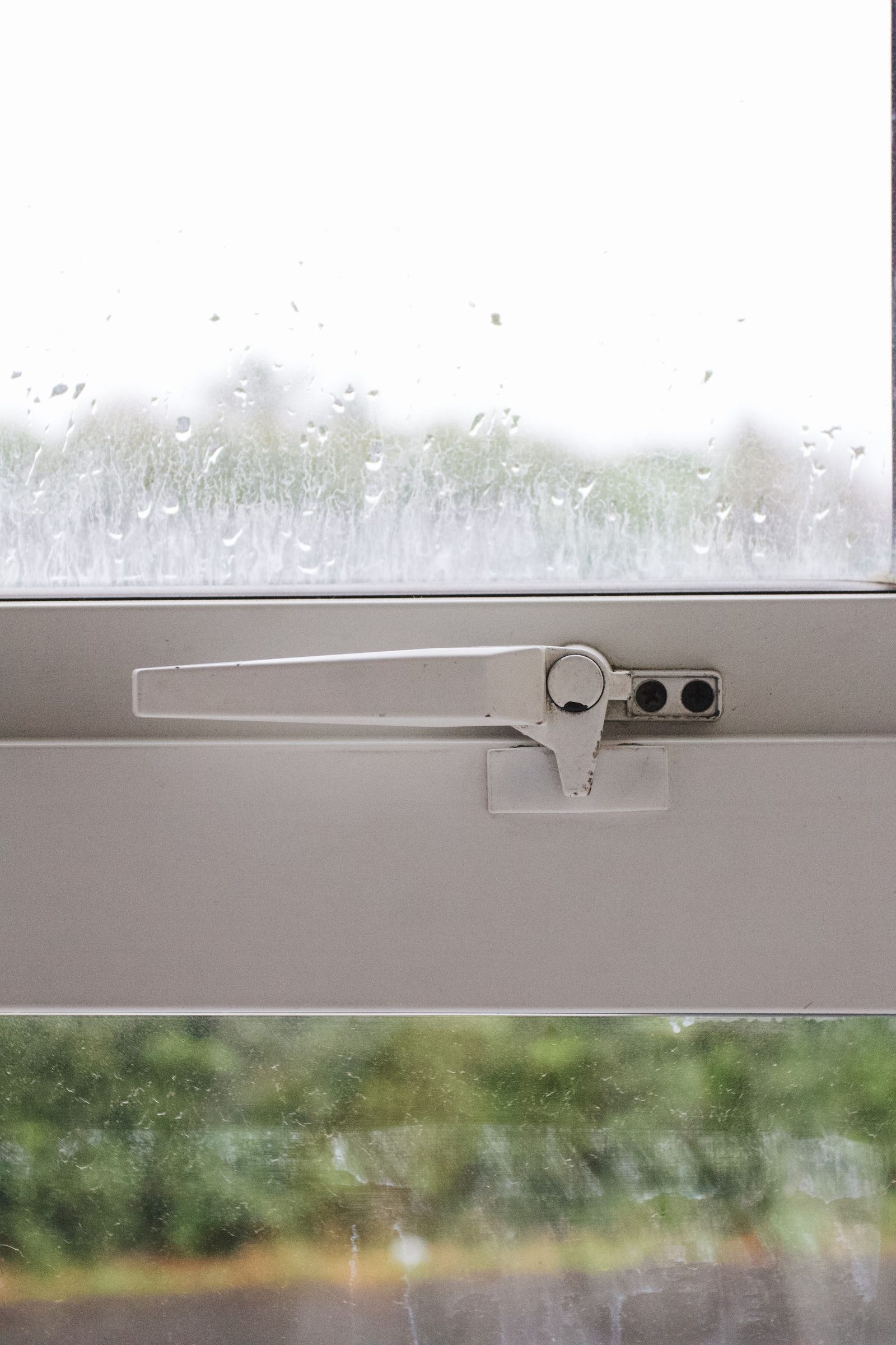 A white uPVC window handle in close-up